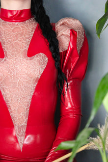 Close detail of the high neck and puff-sleeve latex on the Erato dress