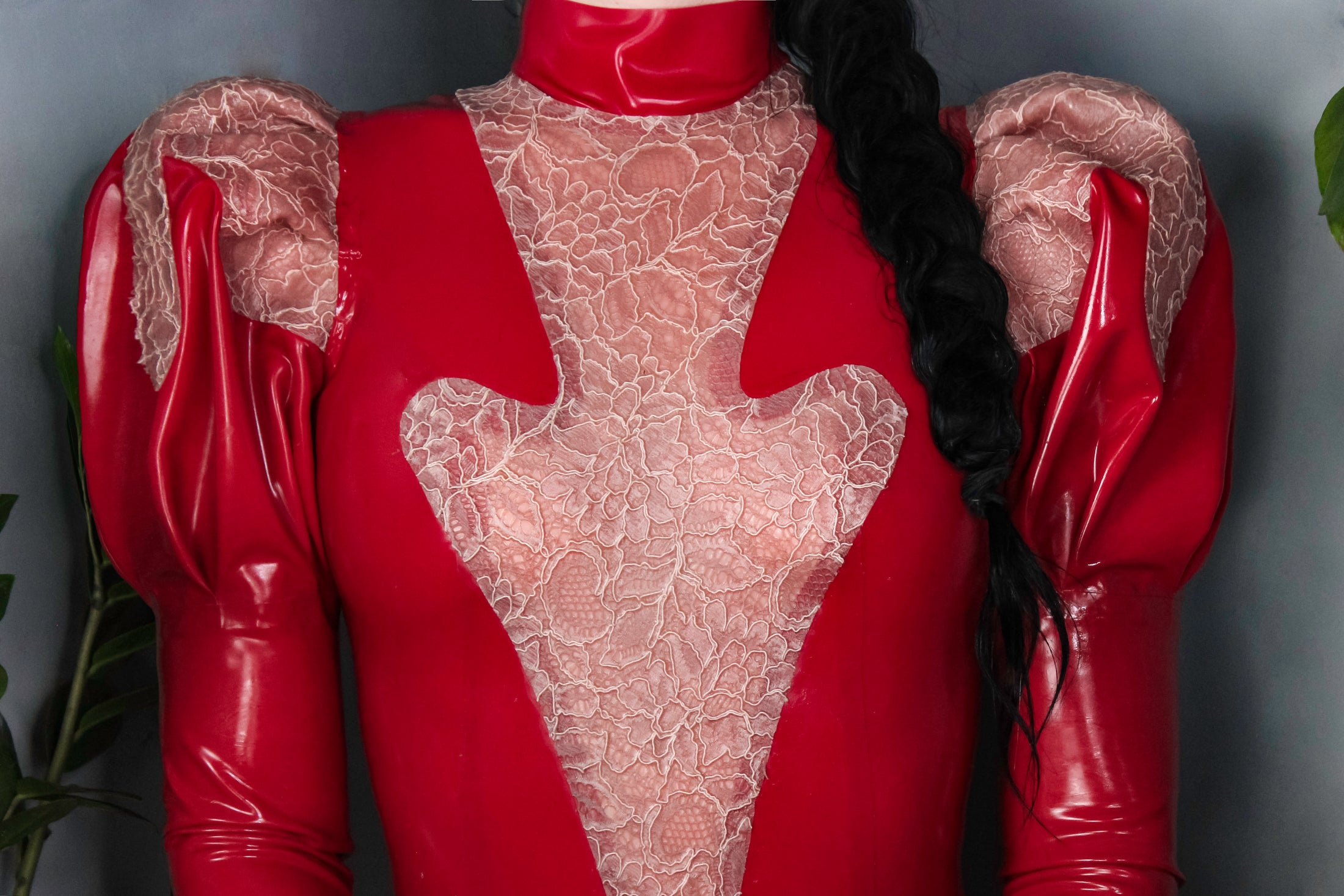 Detail of the custom harness styled with the high-neck Erato latex dress