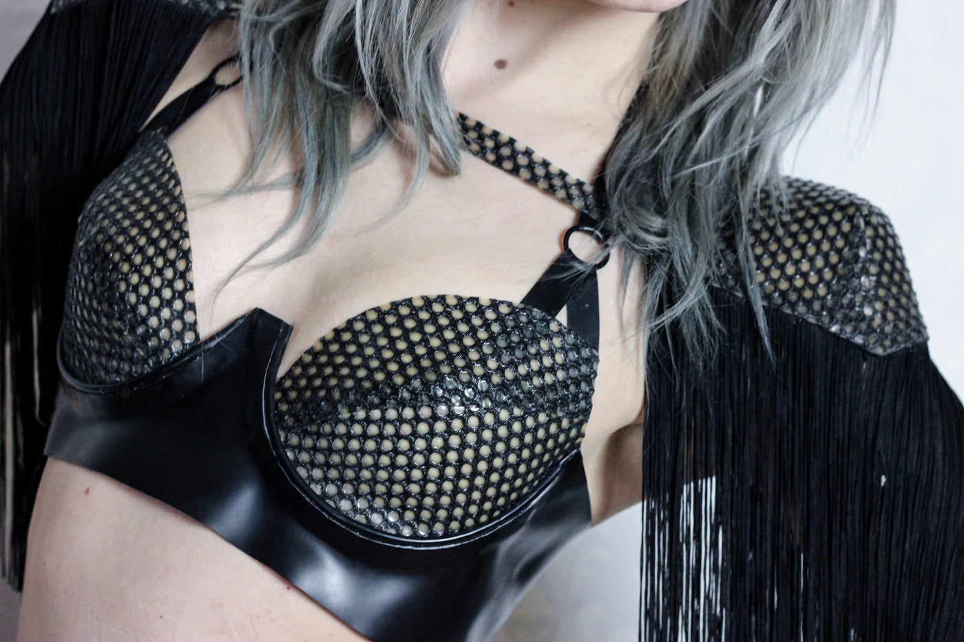 Close detail of the fringing on the textured latex-net shoulder pads