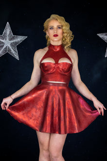 Texture detail of the red glitter-mesh latex on the cropped party top