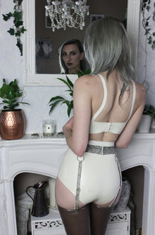 Close detail of the latex waistband and standard leg cut on the belted briefs